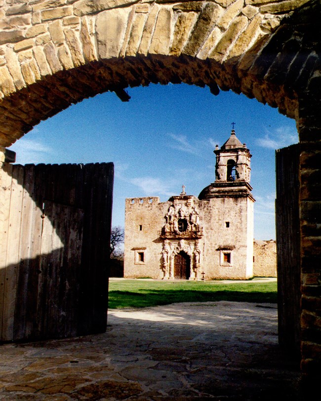 stone gateway and church