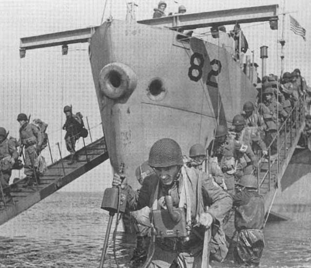 soldiers disembarking from boats into shallow water