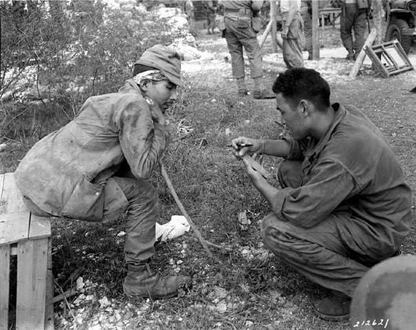 Military Intelligence Language School graduate interrogates a captured Japanese soldier.