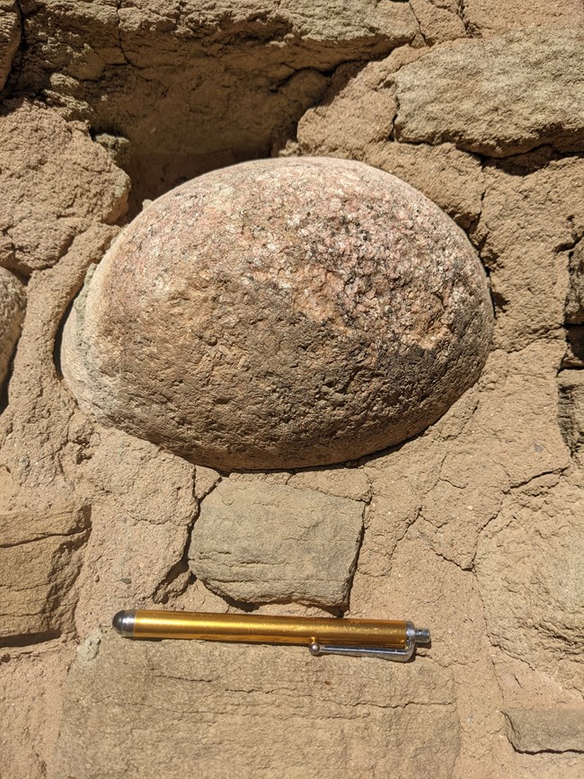 A cobblestone from the Animas River, made of igneous rocks from upstream, used by the ancestral Pueblo people as a building material.