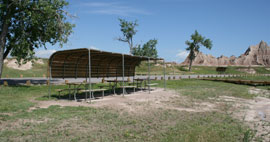 Group campsite with covered picnic tables in the Cedar Pass Campground