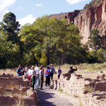 Visitors on a Ranger-led tour of Tyuonyi Village.