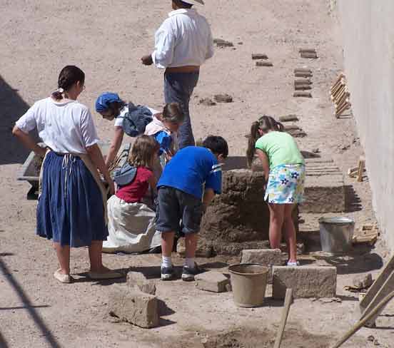 School students making adobe bricks.&nbsp;
