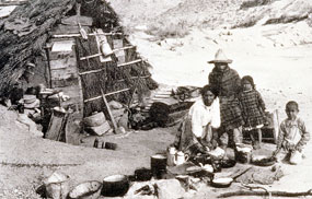 Family of a Mexican laborer at Glenn Springs, outside of their dugout home, 1916.