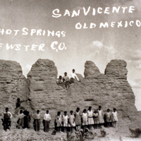 Children standing in front of ruins