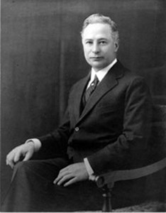 A black and white image of Barron Collier sitting in a chair.