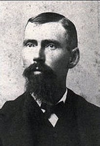 A black and white bust of Charles Torrey Simpson with a large goatee and a bow-tie.