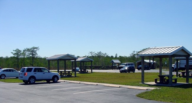 Cars parked near shaded picnic tables at Kirby Storter Roadside Park.
