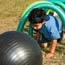 Pretending to be a dung beetle with a giant black ball.