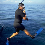 A snorkeler jumps into the water