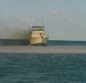 Hard aground on a seagrass flat.