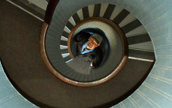 A man looks up from the bottom of the circular stairway in Cabrillo National Monument's Point Loma lighthouse.