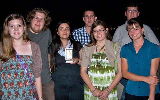 Seven students pictured with the Sierra Club Green Award trophy.