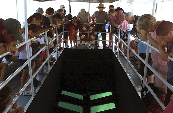 A park ranger leads a tour on the glass bottom boat.