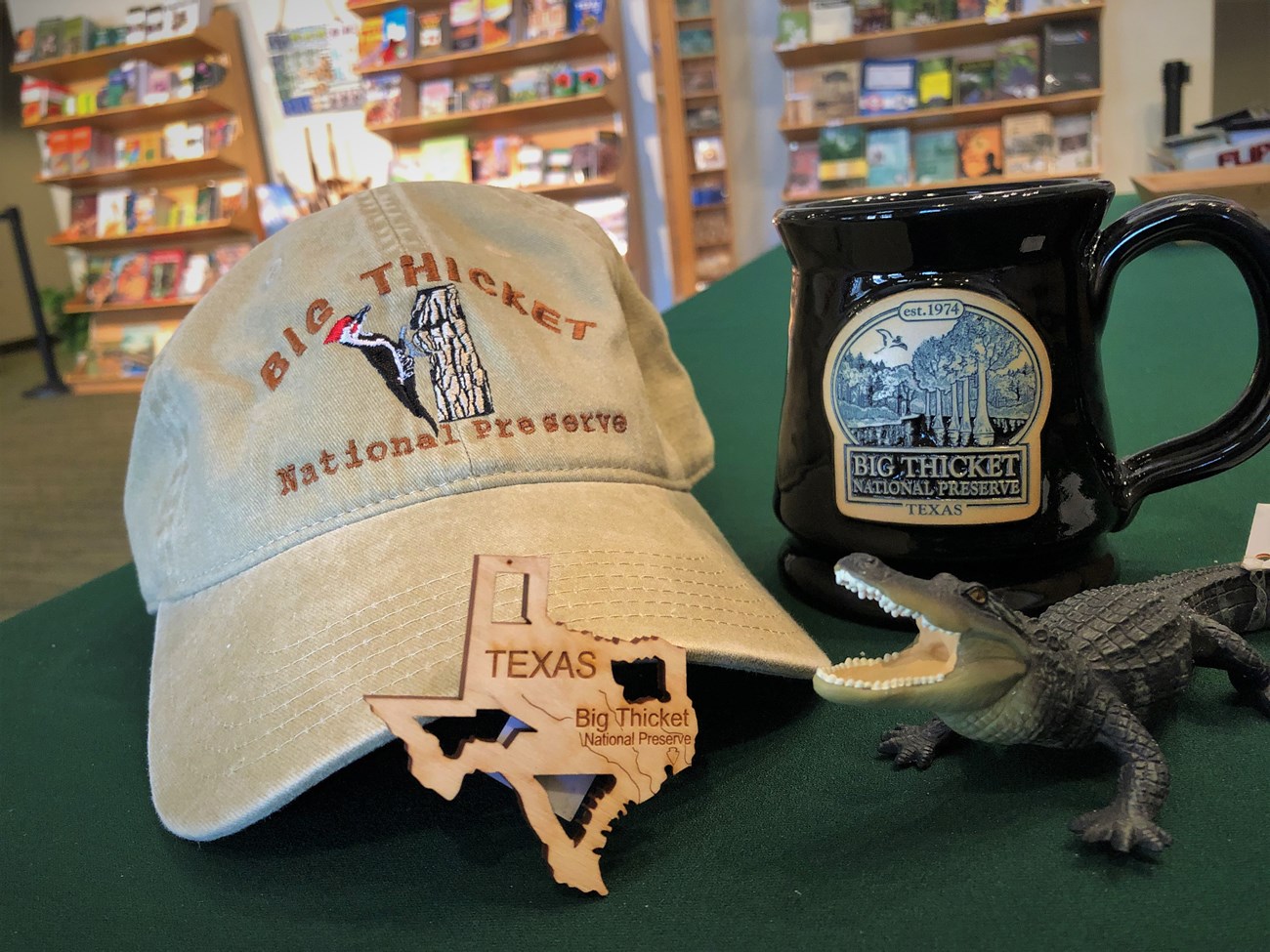 an assortment of souvenirs including a ball cap, texas-shaped magnet, alligator, and coffee mug