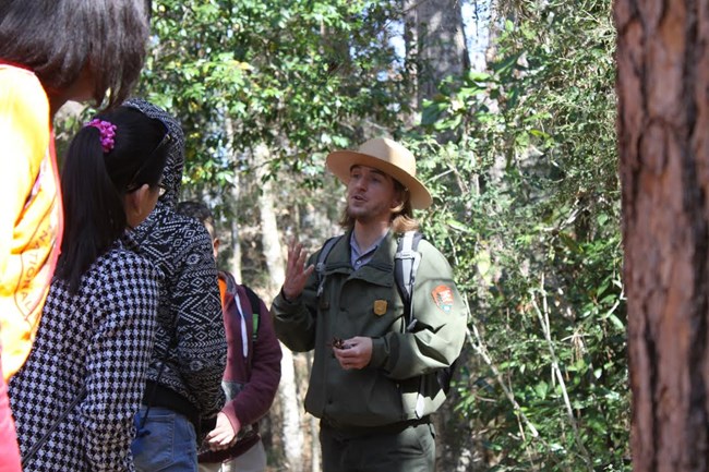 a ranger talking to a group outside