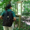 hiker reading trail sign