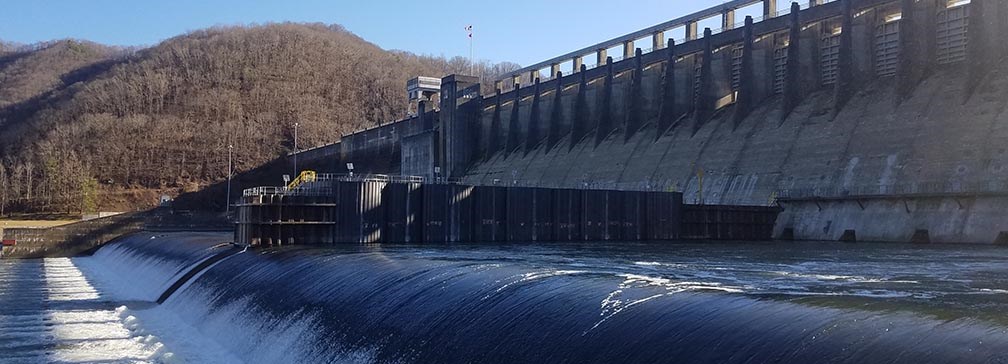 water flowing from the bottom of a large dam