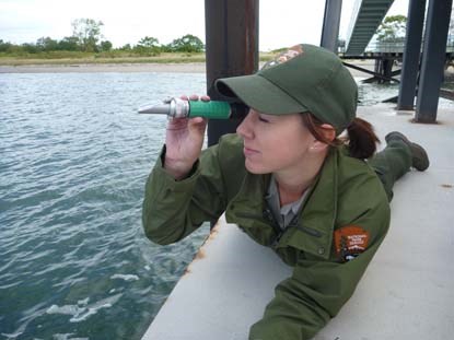 Ranger uses a refractometer to check water salinity.