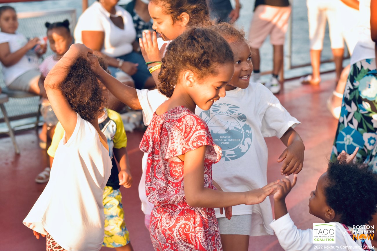 Girls playing and dancing on the upper level of a ferry