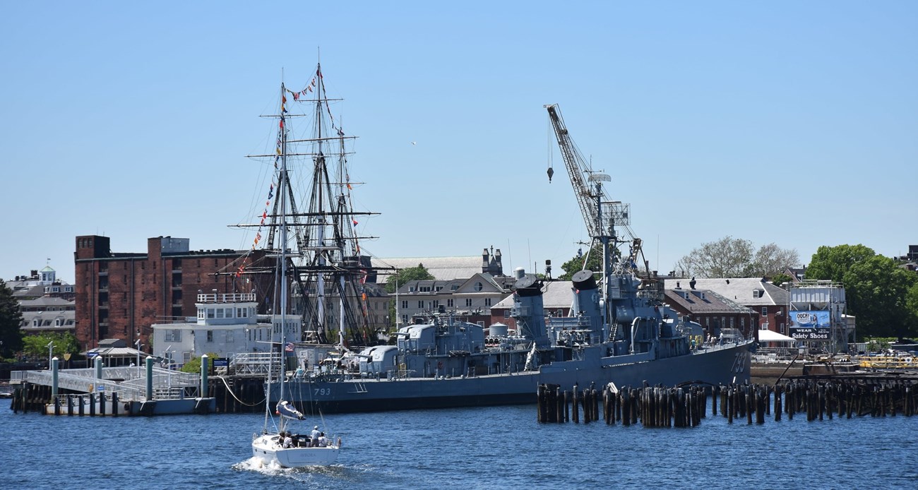 historic naval shipyard with destroyer in foreground