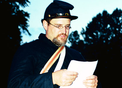 Actor protraying a Union Soldier reading Emancipation Proclamation to slaves.