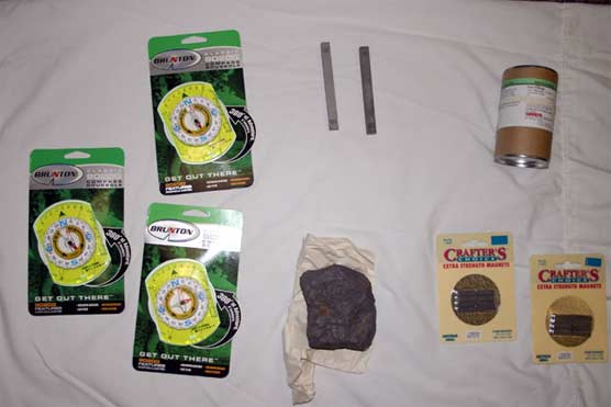 contents of the earth systems discovery chest - 3 compasses, 2 bar magnets, iron fillings, Magnetite sample, extra strength magnets.