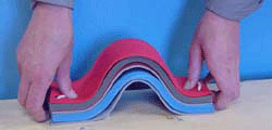 Folded foam boards with string, displaying mountain folds, by being pushed toward the middle
