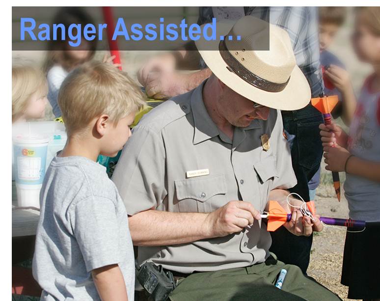 Ranger helps child prepare model rocket for launch