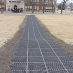 The pedestrian pathway made with 100% recycled materials, leading from the parking lot to the front entrance.