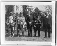 President Calvin Coolidge posed with Native Americans, possibly from the Plateau area in the Northwestern United States, near the south lawn of the White House. Photo, 1925.