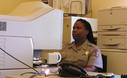 Park Ranger Nichole McHenry researches information on microfilm in the research library.