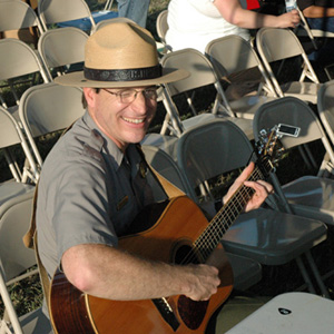 New Nicodemus acting superintendent Dave Schafer playing banjo in the Flint Hills