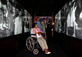 Little Rock nine members watch themselves in historical news footage.