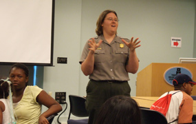 Park Guide Amy Genke presents protest music to local library patrons.