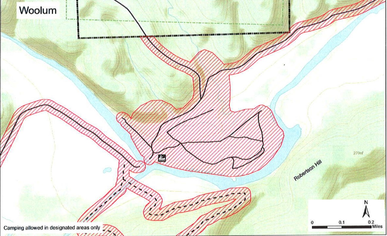 topographic map of Woolum access area, safety zone no hunting shaded red, roads solid black lines, trails dashed black lines, mileage and compass direction at bottom right