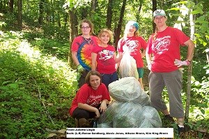 4 Girl Scouts and leader remove garlic mustard along trail