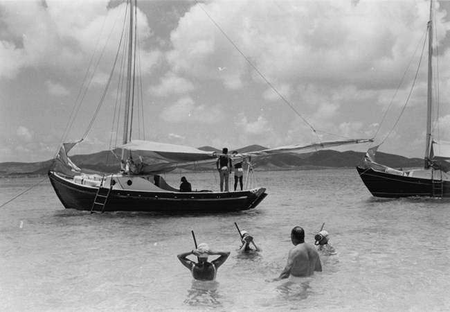 1960s black and white photo of snorkelers and sailboats at Buck Island