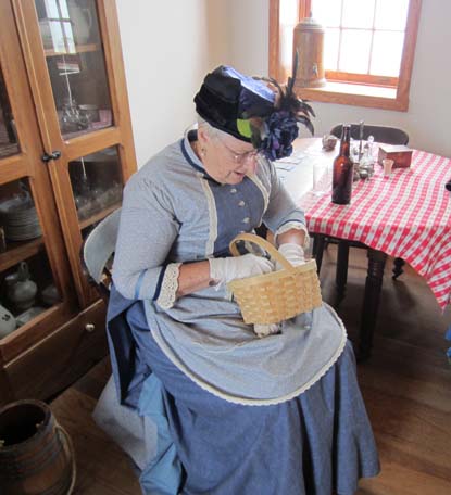Living history volunteer Suzann looks for a recipe