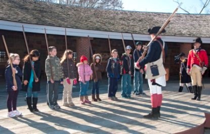 Children take part in musket drill.