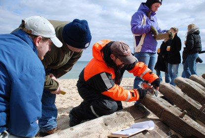 Professor David Robinson (center) and students measuring the wreck.