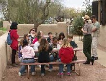 Park Ranger Denise Shultz and Volunteer Erv Barnes welcome a visiting school group.