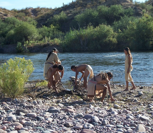 costumed actors are using traditional tools to start a canal at the Salt River