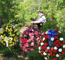 A bagpiper plays following the memorial service at the Hatteras Island British Cemetery