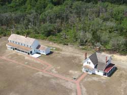 The principal keeper's quarters (left) and the double keepers' quarters as viewed from the top of the Cape Hatteras Lighthouse.