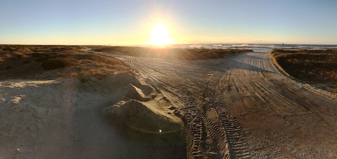 The sandy off-road vehicle routes Inside Road (left) and Beach Access Ramp 48 (right) during sunrise.