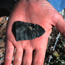 Image of archeologist holding an artifact found in an excavation