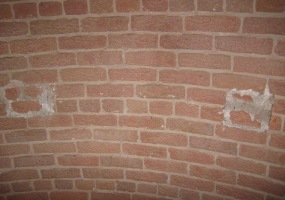 Where wooden staircase connected to interior wall