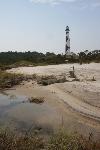 Seasonal water pump along back road covered in sand