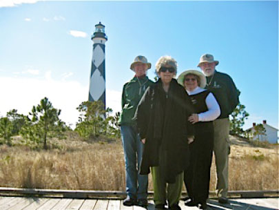 lightkeeper's daughters pose near the lighthouse with park VIPs
